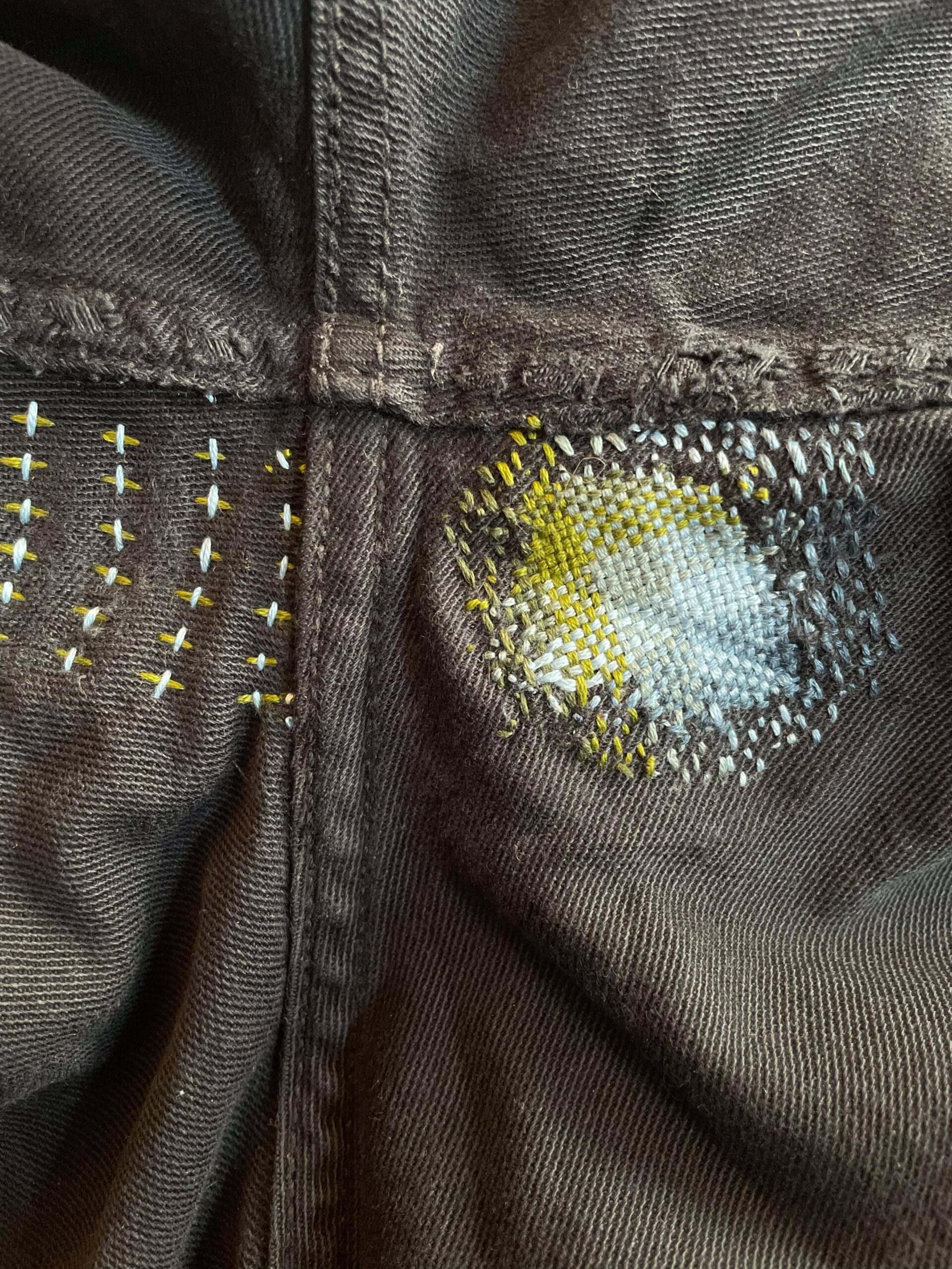 A jean crotch repair, with sashiko stitching on the left and visible mending (darning) on the right