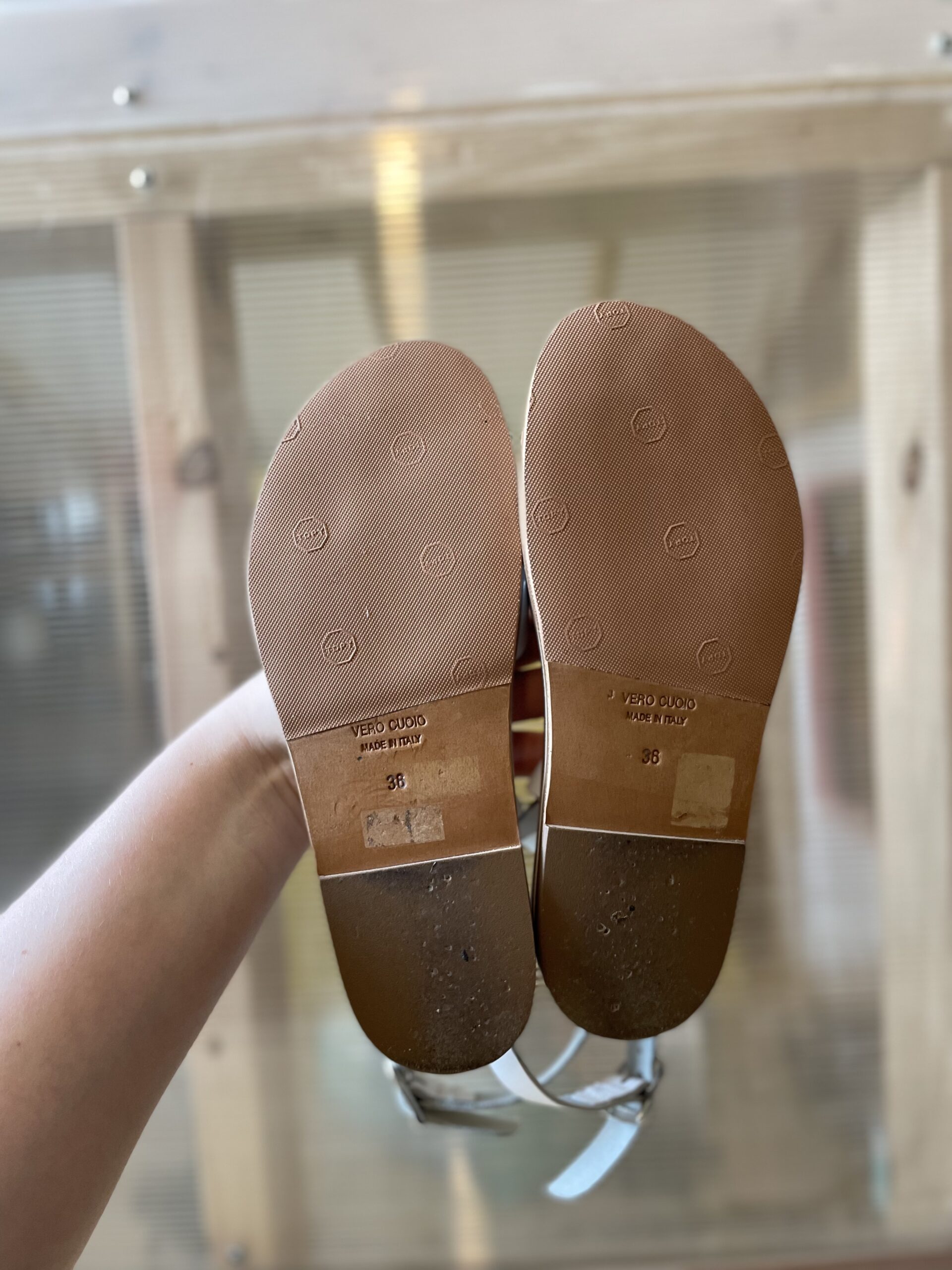 A pair of sandals, with the soles facing outwards, showing topy halfsoles