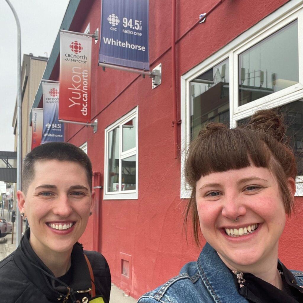 Tess and Ariss smiling in front of CBC Yukon